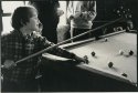 Some kid playing pool