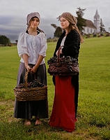 Two Young Women Picking Grapes