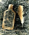 Bottle and Feather - Grass Background