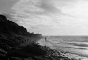 Seaside, setting sun, people on beach