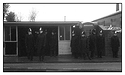 Policemen at bus stop in the pouring rain