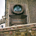 Statue of Charles Dickens on wall of his former house