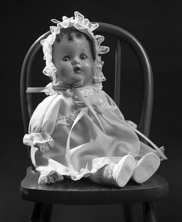 Doll on chair