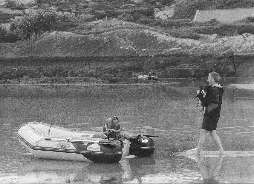 Fisherman and unwilling dog.