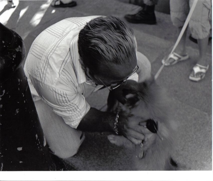 Guy kissing dog