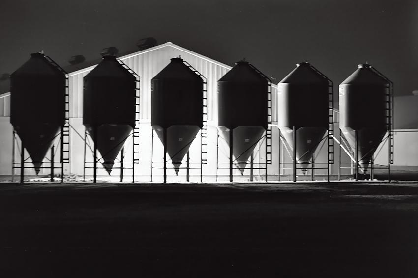 the hog house feed bins at night