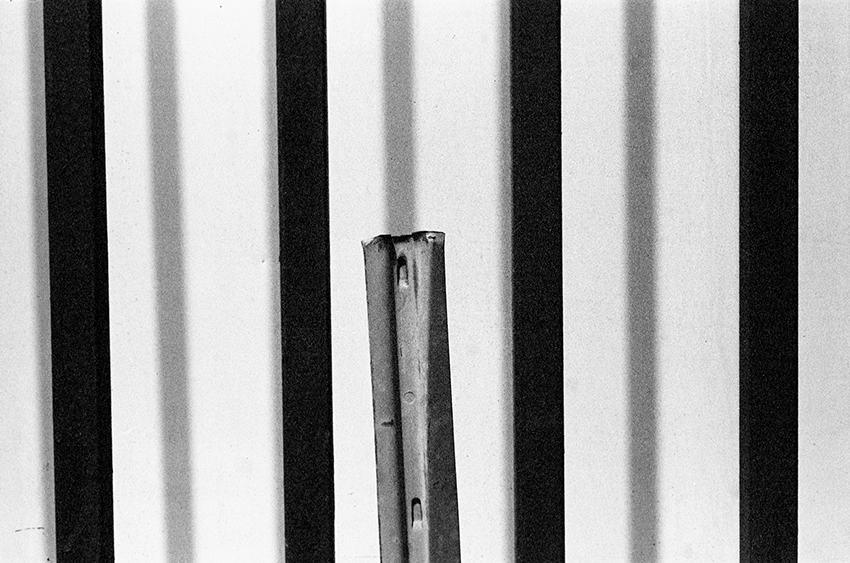 Vertically Corrugated Wall and Severed Street Sign